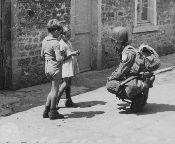 101st Airborne Div Paratrooper with french children normandy dday 060844  (1 of 1)